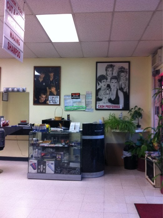Reception area with retro hairstyle posters at Cherry Hair Design